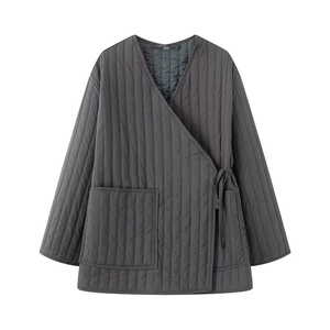 Detailed view of dark gray quilted kimono jacket with side ties and large pockets for autumn