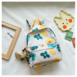 Detail of white nylon backpack with floral prints and matching round coin purse charm