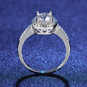 Detailed macro view of silver halo ring featuring brilliant cut stone and pavé band