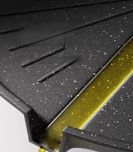 Detail view of the maifan stone coating and oil drainage slot for healthy BBQ cooking