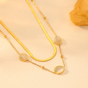 Double-layered 18k gold plated stainless steel necklace featuring white cat eye stones