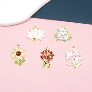 Detailed view of five colorful enamel flower pendants including rose and sunflower