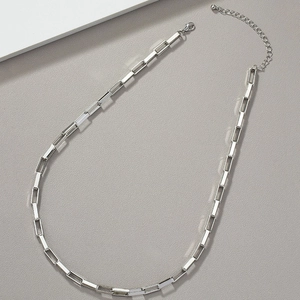 Close-up of silver geometric square link chain with adjustable extension and lobster clasp