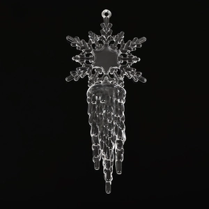 Macro shot of transparent acrylic snowflake and icicle ornament on black background