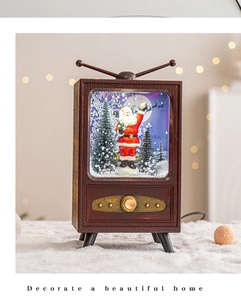 Close-up of vintage TV snow globe with Santa and lighting for Christmas decor