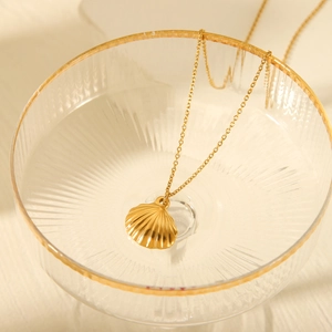 Elegant gold shell pendant necklace in a glass cup with fine titanium steel chain