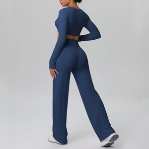 Detail of dark blue yoga set showing high-waisted wide-leg pants and cropped long sleeve