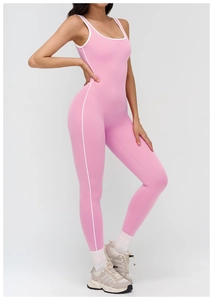 Detail shot of pink yoga jumpsuit showing white contrast piping and square neckline