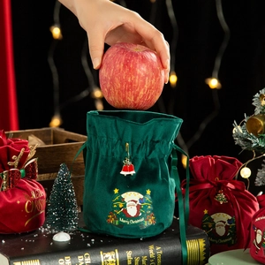 Green and red velvet Christmas gift bag with drawstring and festive Merry Christmas print