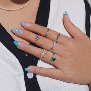 Detail of luxury S925 sterling silver rings with emerald, heart crystal, and evil eye motif