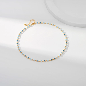 Detail of 18K gold-plated chain with blue evil eye beads and adjustable lobster clasp