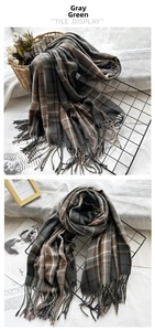 Close-up of grey-green plaid scarf with soft fringe and thick cashmere-like texture