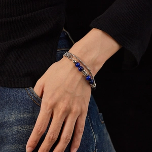 Detailed close-up of double-layer stainless steel bracelet with blue tiger eye stone beads