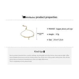 Detail view of gold-plated bracelet showing cat eye stone and zircon bow design