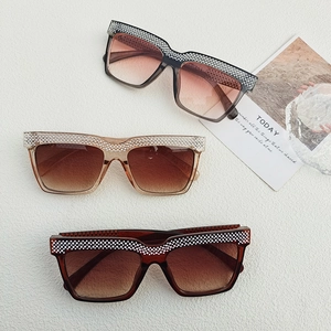 Detail of oversized flat top sunglasses with luxury rhinestones and gradient lenses