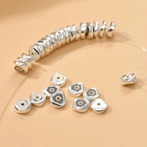 Macro shot of silver wave-cut hematite spacer beads for DIY jewelry making