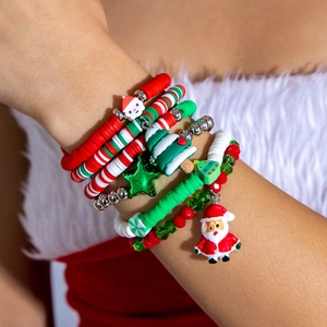 Close-up of a festive Christmas beaded bracelet set with Santa and reindeer charms on wrist