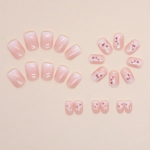 Short square press-on nails with pink gradient and delicate cherry blossom flower designs