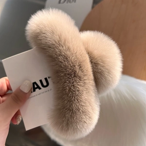 Close-up of soft khaki rabbit fur hair claw clip with fluffy texture and warm tones