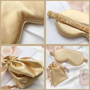 Champagne gold silk sleep mask set with matching drawstring bag on elegant satin background