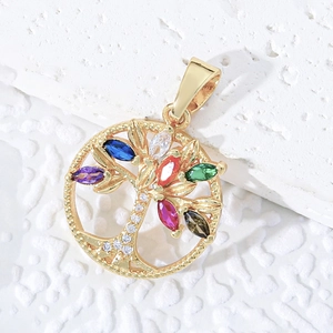 Gold tree of life necklace with colorful marquise gemstones on textured stone background