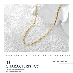 Detailed view of a gold Cuban link chain necklace displayed on a white plaster bust