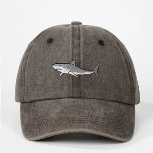Close-up of shark embroidery on a vintage washed dark grey cotton baseball cap