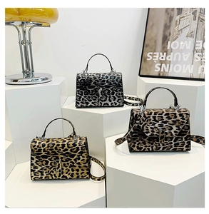 Chic leopard print handbags in brown and grey tones with metal locks on display