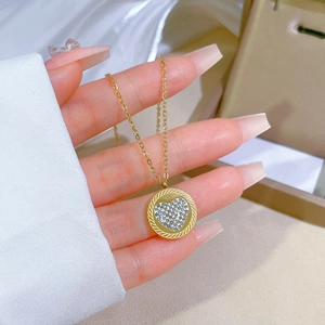 Macro view of golden heart necklace with pavé crystal inlay and rope texture detail