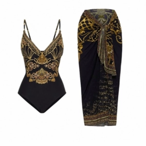 Detail view of two-piece swimwear set with golden baroque print and matching sarong skirt