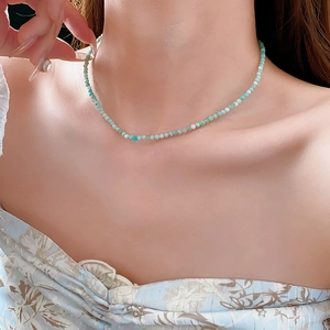 Close-up of Amazonite stone beaded necklace on model neck in soft natural light