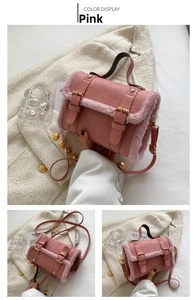 Detailed view of pink faux suede and fur handbag with golden hardware and strap