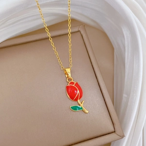 Elegant gold titanium steel necklace featuring a red tulip pendant and delicate leaf