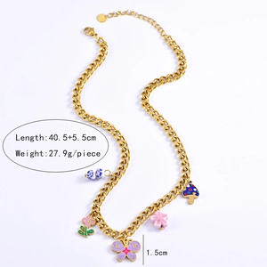 Detail of gold curb chain necklace with colorful butterfly and floral enamel pendants