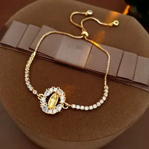 Adjustable gold bracelet featuring a Virgin Mary oval pendant with sparkling zircon accents