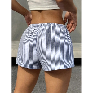 Back view of women's blue and white striped shorts with elastic waistband outdoors