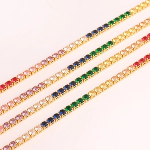 Close-up of gold-plated necklaces with colorful zircon stones in various vibrant shades