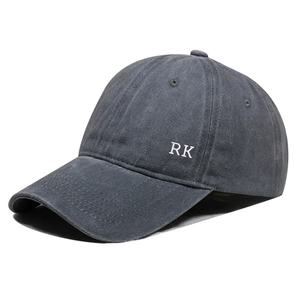 Detail of white RK embroidery on side of dark grey washed cotton baseball cap