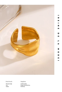Detail of gold wide irregular molten texture ring with adjustable open design