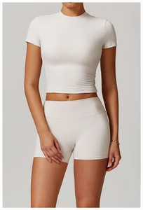 Close-up of the smooth matte texture and seamless hem of the cream yoga crop top set