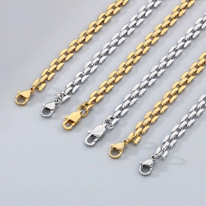Close-up of gold and silver titanium steel bracelet chains with secure lobster clasps