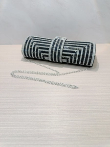 Detail shot of the elegant black evening clutch with silver rhinestone geometric patterns