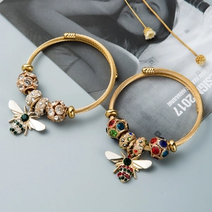 Golden adjustable bee charms bracelet with sparkling rhinestones and twisted metal craft