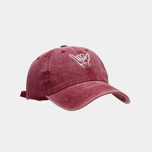 Close-up of Shaka gesture embroidery on burgundy washed cotton baseball cap