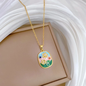 Detail of floral enamel oval pendant with small diamonds on a gold necklace chain