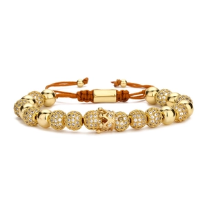 Close-up of gold crown charm and micro-pave zircon beads on woven adjustable bracelet