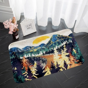 Detailed close-up of a flannel mountain landscape absorbent rug on a dark wood floor