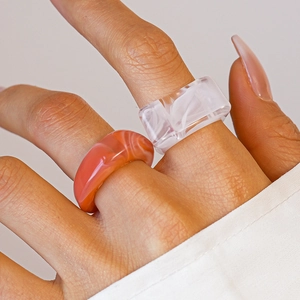Detail of model wearing a two-piece set of acrylic marble pattern resin rings