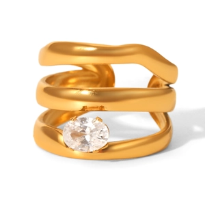 Macro detail of triple-layer gold geometric ring featuring an oval clear zircon stone