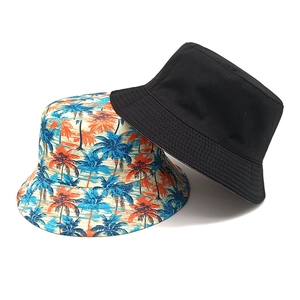 Summer bucket hats with tropical palm tree print and classic black cotton fabric design